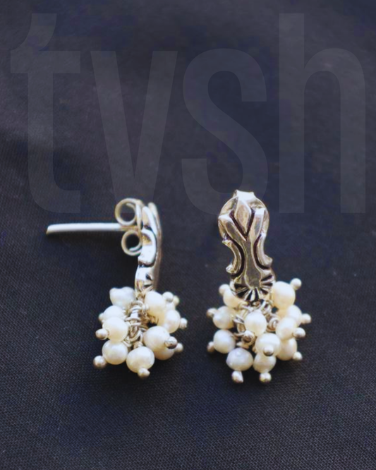 Press and lock silver stud with pearl bunch