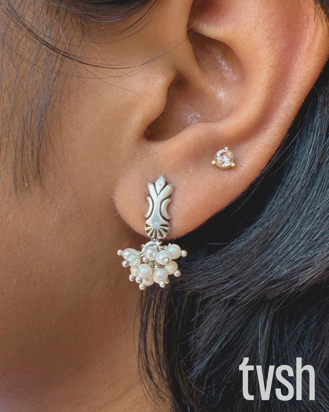 Press and lock silver stud with pearl bunch