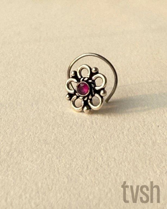 Small wired silver flower nose pin with a small red semiprecious stone